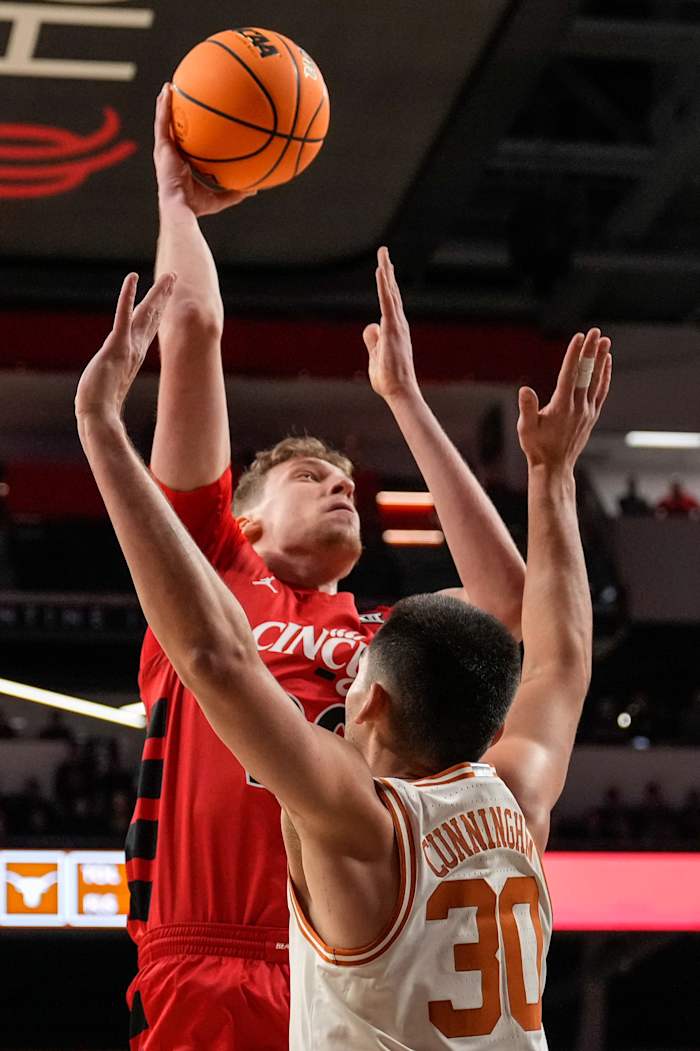 Cincinnati Bearcats forward Viktor Lakhin (30) rises above Texas Longhorns forward Brock Cunningham (30) in the first half of the NCAA Big 12 basketball game between the Cincinnati Bearcats and the Texas Longhorns at Fifth Third Arena in Cincinnati on Tuesday, Jan. 9, 2024.